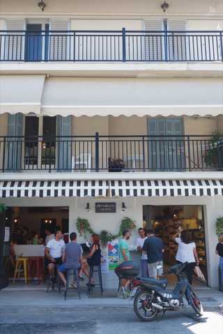 People sitting in the sun outside a coffee shop
